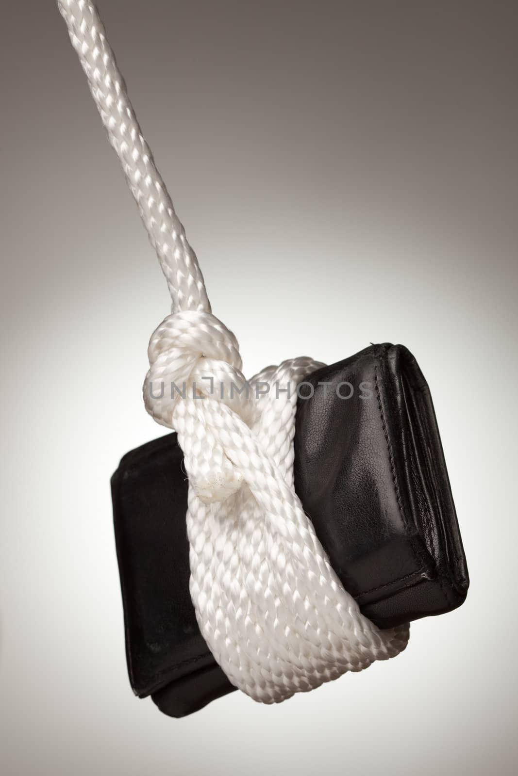 Tied Up and Hanging Wallet on a Spot Lit Background.