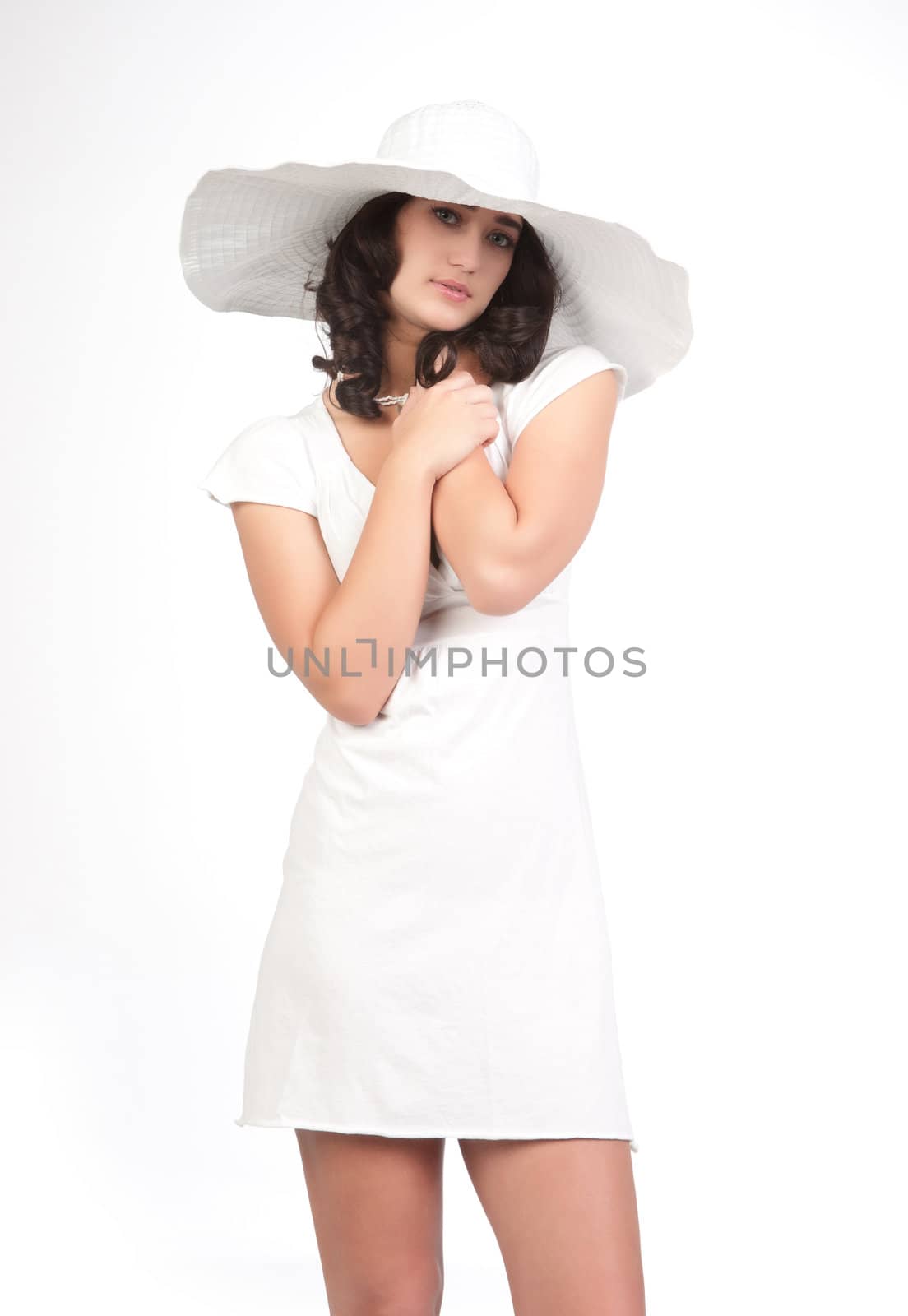 beautiful young fashion woman in white dress and hat