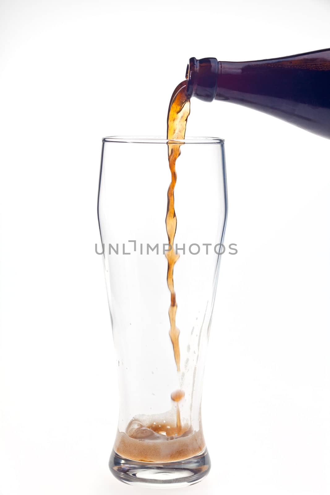 pouring dark wheat beer in a glass