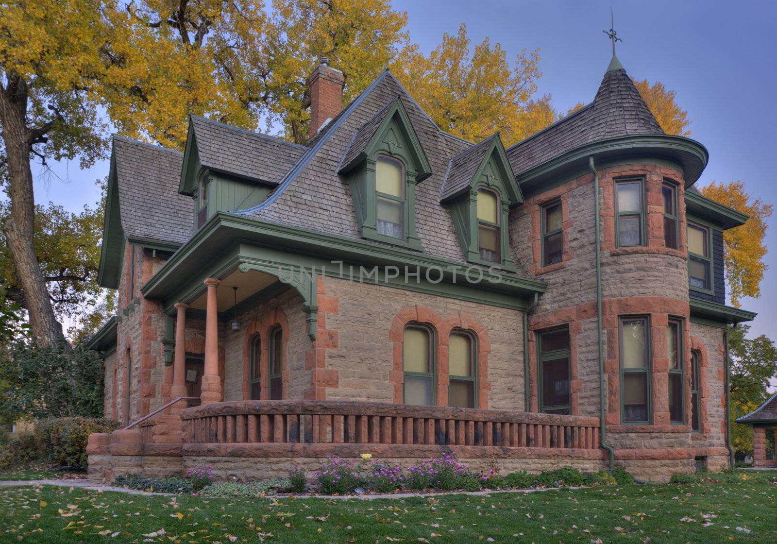 Avery house - historical landmark of Fort Collins, Colorado, at dawn against fall cottonwood foliage