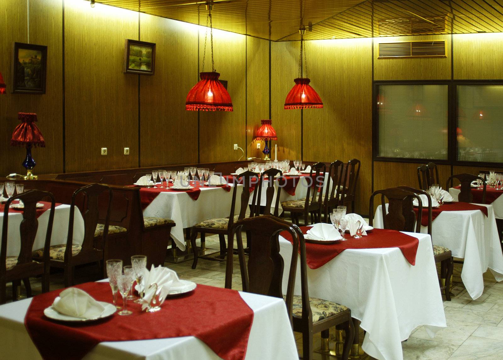 The cozy interior of the restaurant with red lights