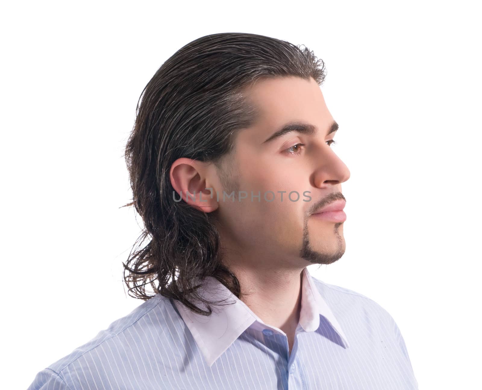 Young dark haired caucasian man wearing light blue striped shirt looking sideways isolated on white