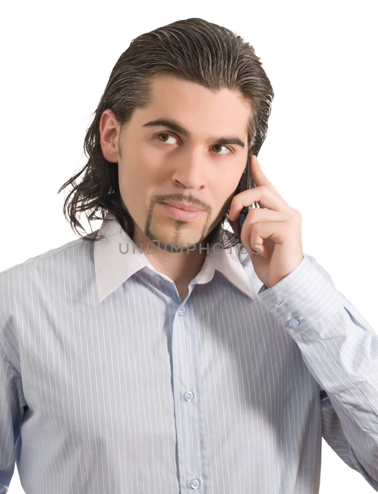 Young dark haired caucasian man in light blue striped shirt talks on the phone isolated on white