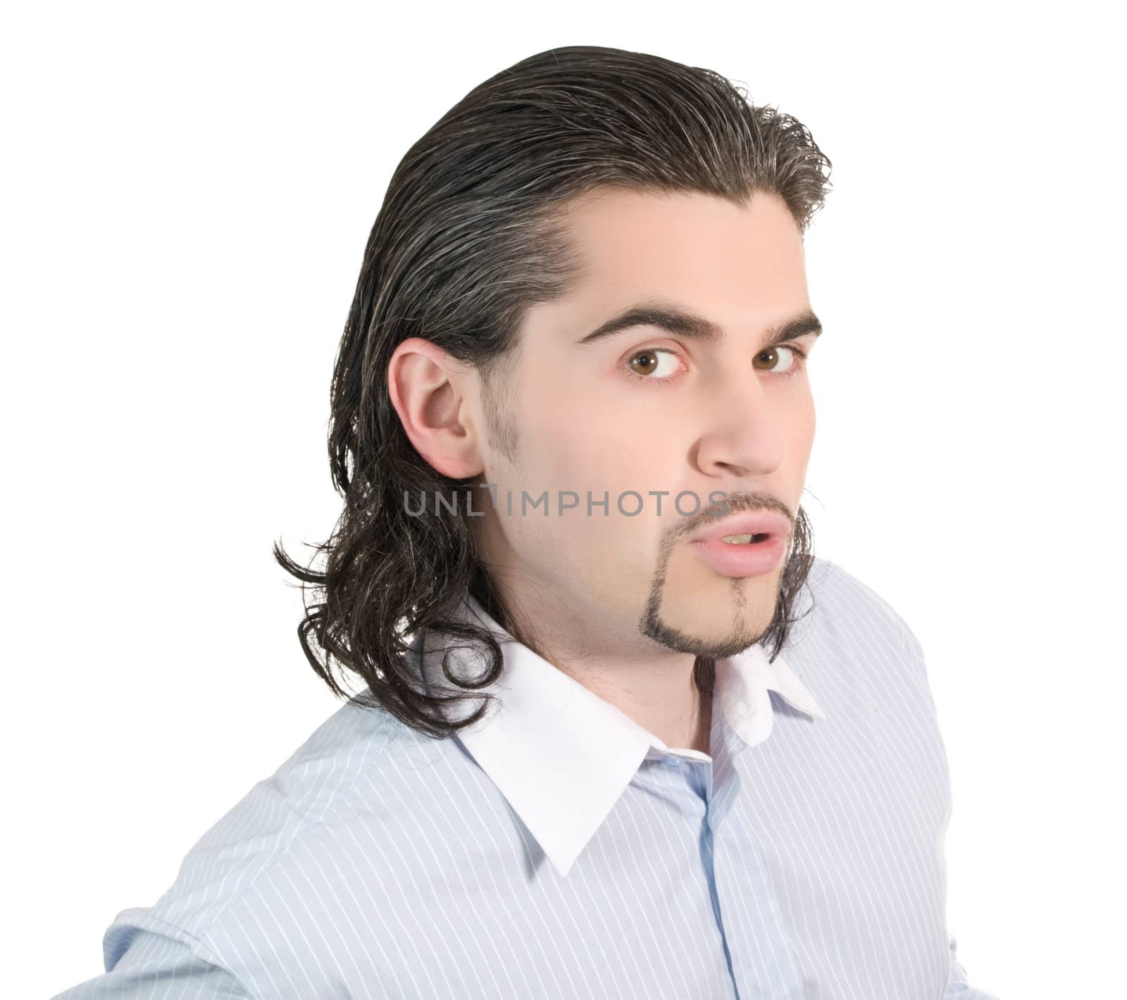 Young dark haired caucasian man in light blue striped shirt looking curiously isolated on white