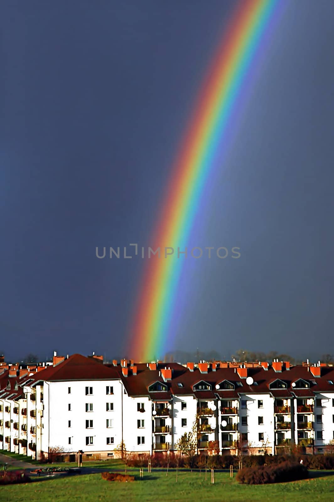 Beautiful, colorful rainbow above housing estate