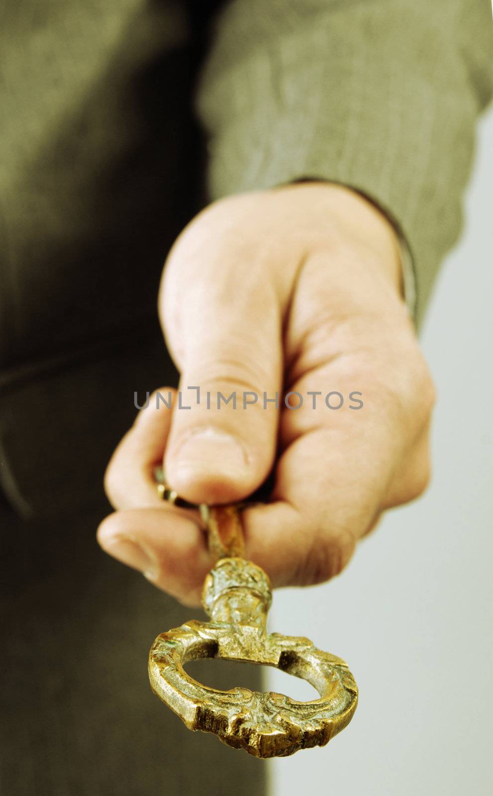 Businessman handing a success key  by cienpies