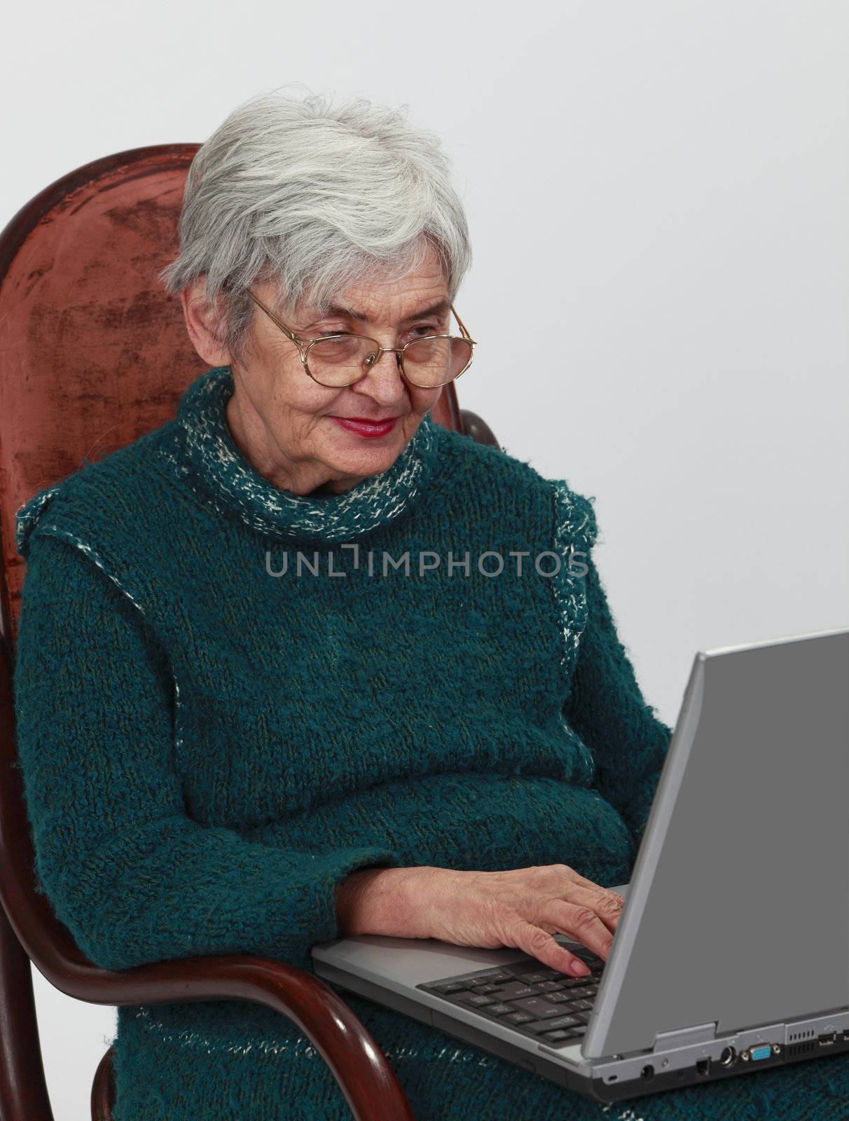 Close-up image of a senior woman using a laptop.