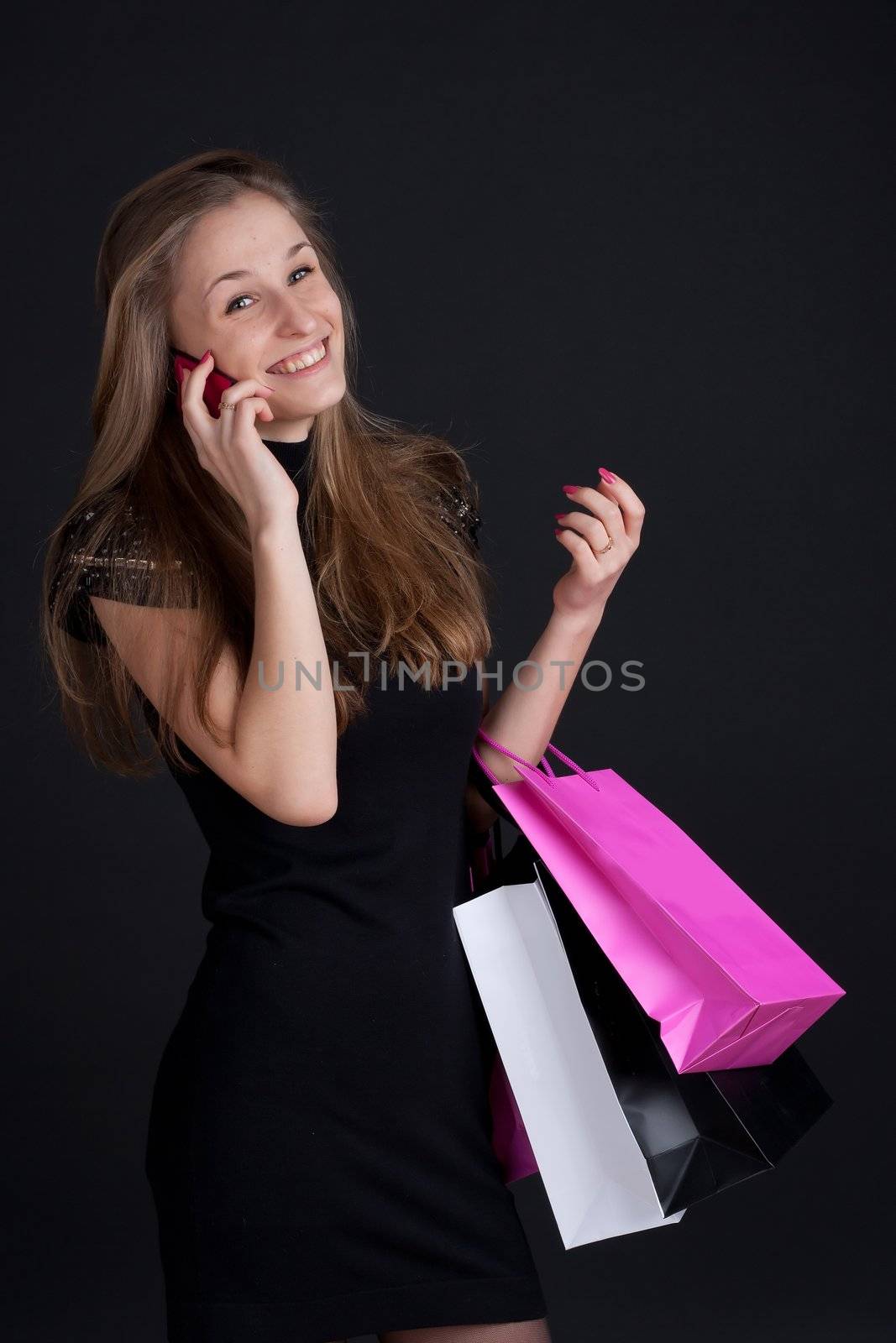 Girl with shopping on the phone by victosha
