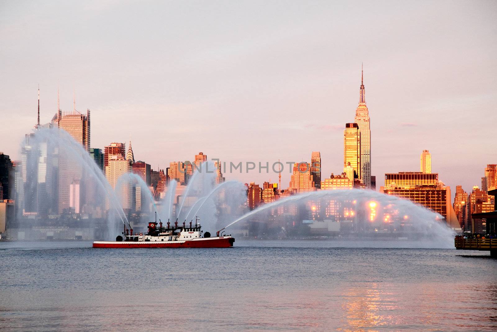 NEW YORK CITY - JULY 4, 2009: Fireboat waterjet show prior to the largest firework in the America - Macy's 4th of July fireworks which featured more than 40,000 shells.