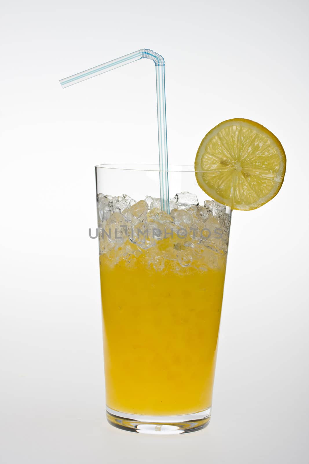 glass of orange juice with lemon slice and straw