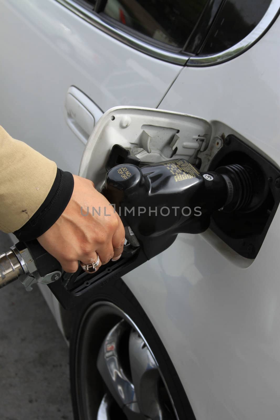 Close up of a person pumping gas.