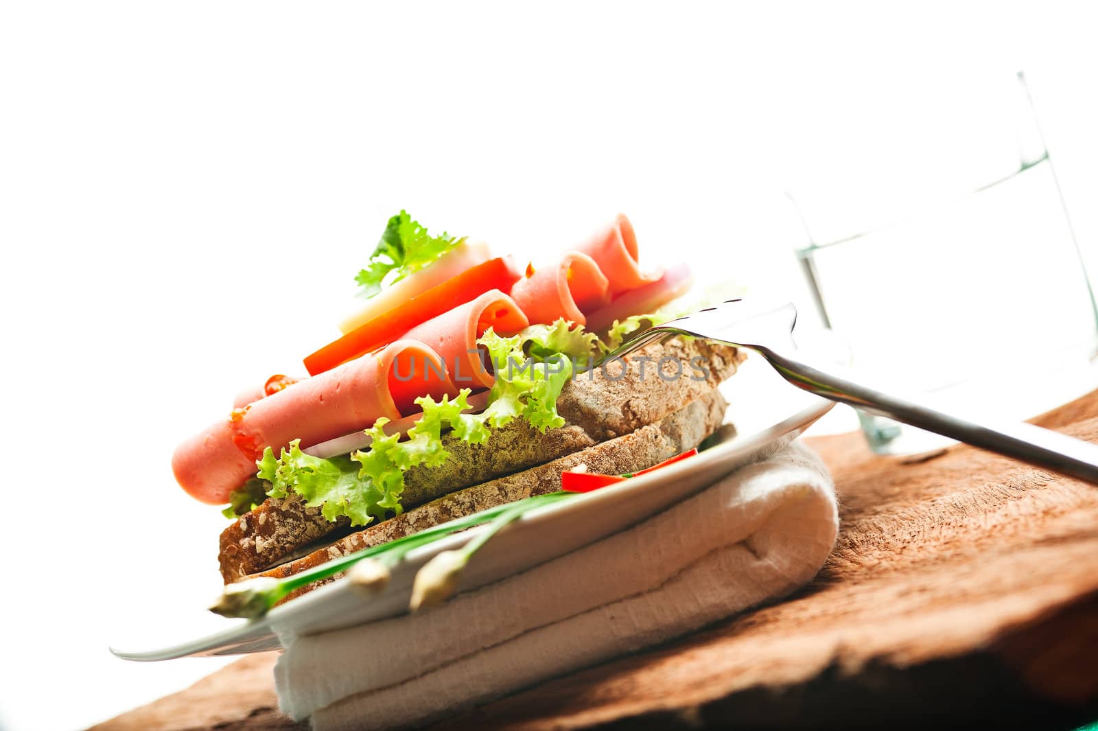 Brown bread with chili sausage slices green salad tomato and egg