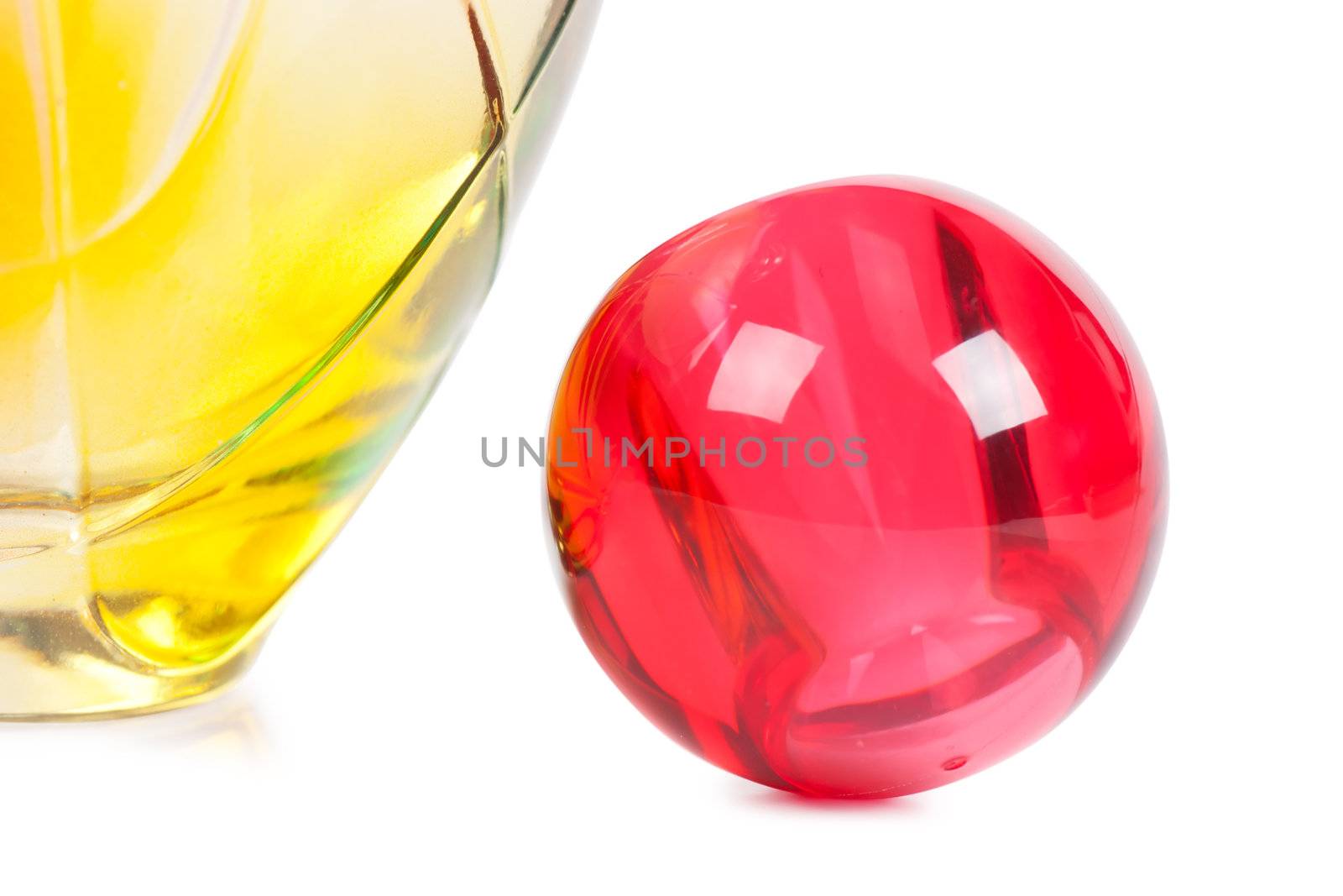 Colorful transparent perfume bottle over white background