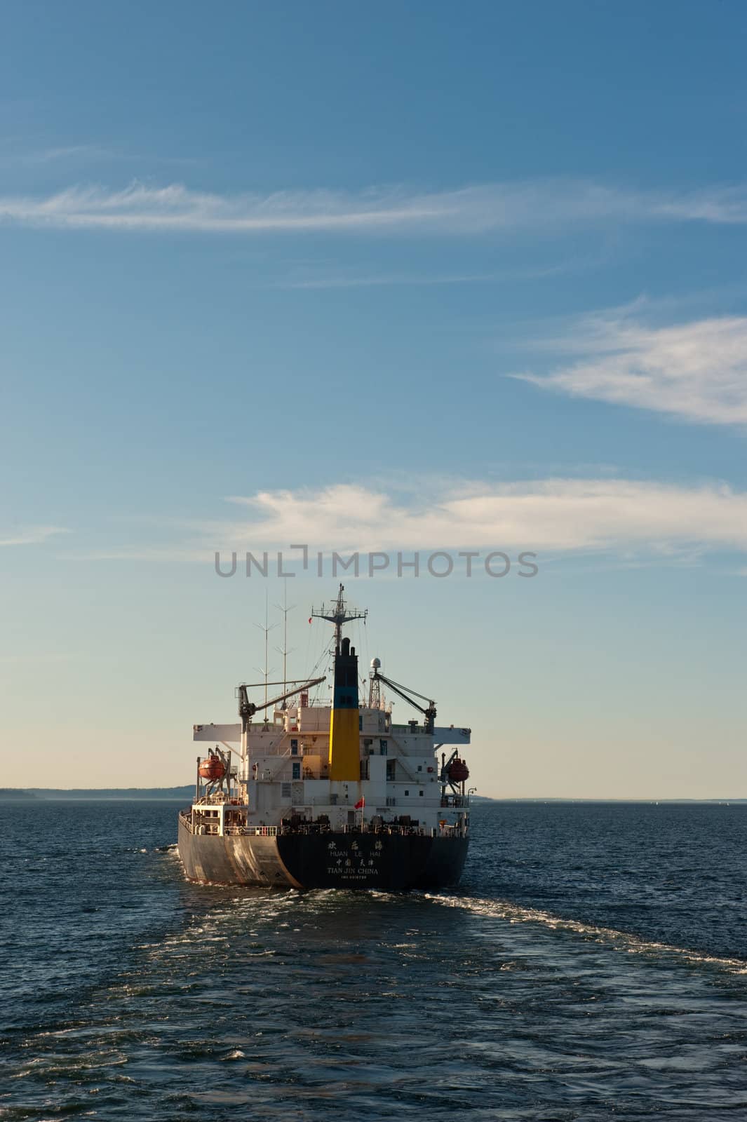 ship seen from behind, heading to ocean