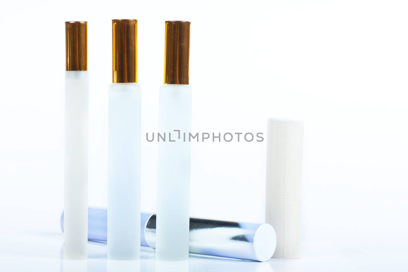 Three white and blue perfume bottles