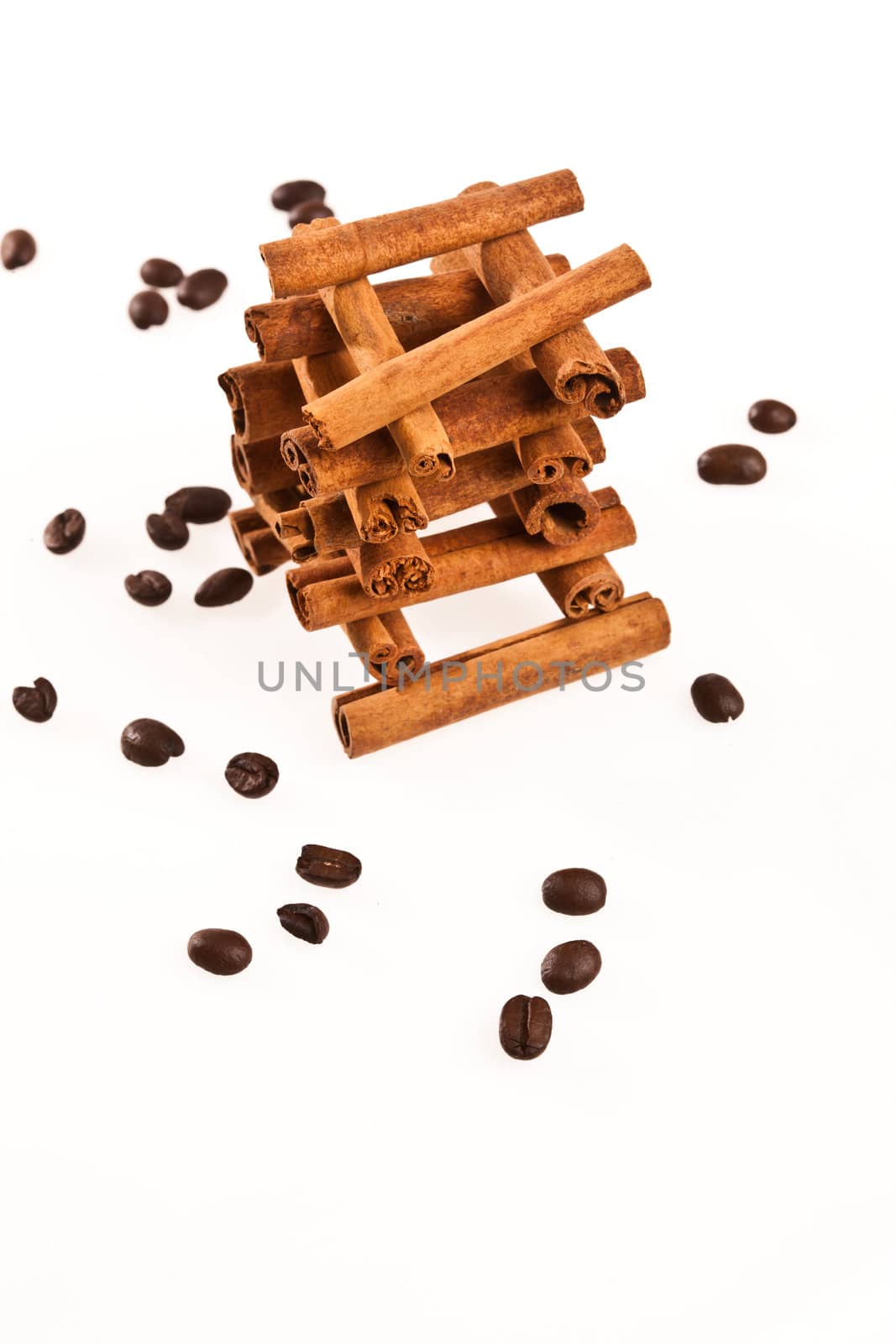cinnamon sticks and coffee beans on white