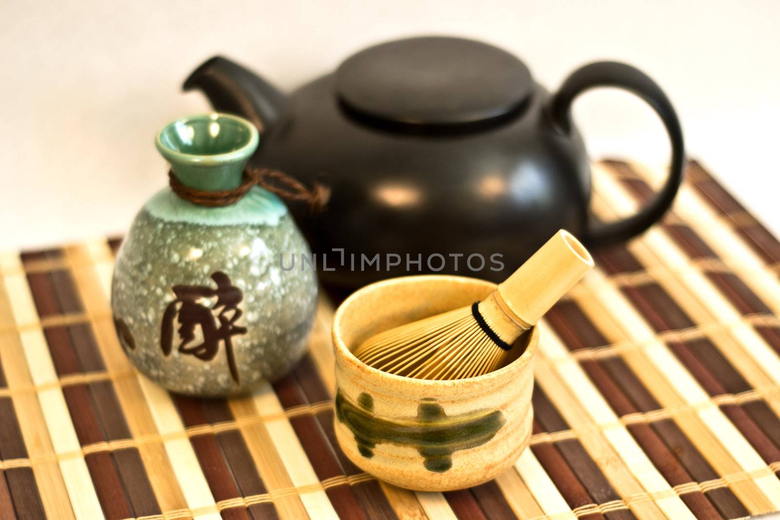 Traditional asian teaware and other pottery, including sake jar.