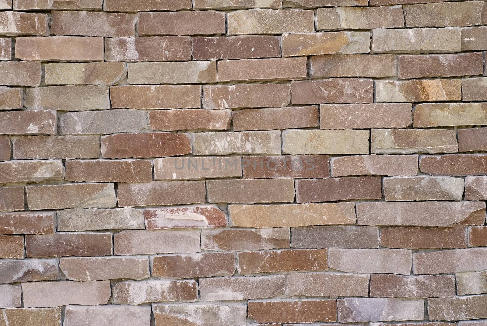 It is a stone wall with brown color.