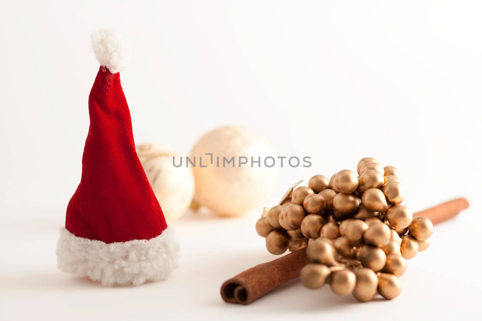 Christmas balls, Santa Claus hat  and a cinnamon stick