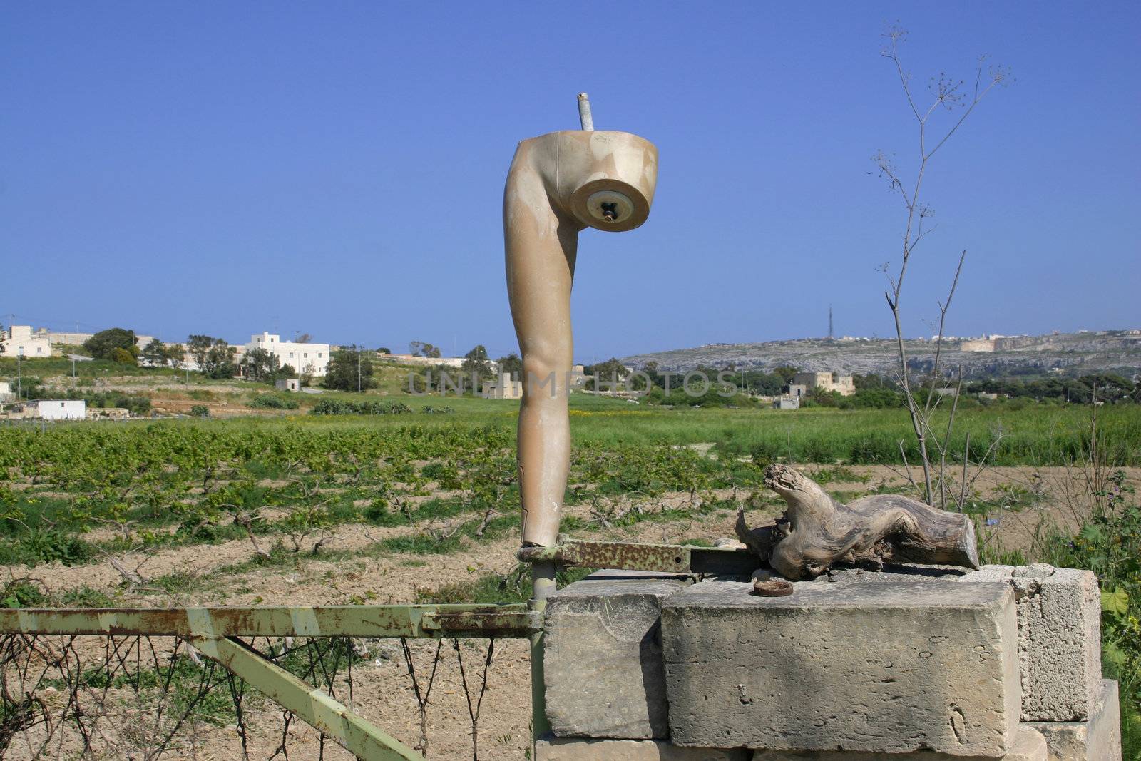 A part of an old mannequin is used as a gatepost in Malta