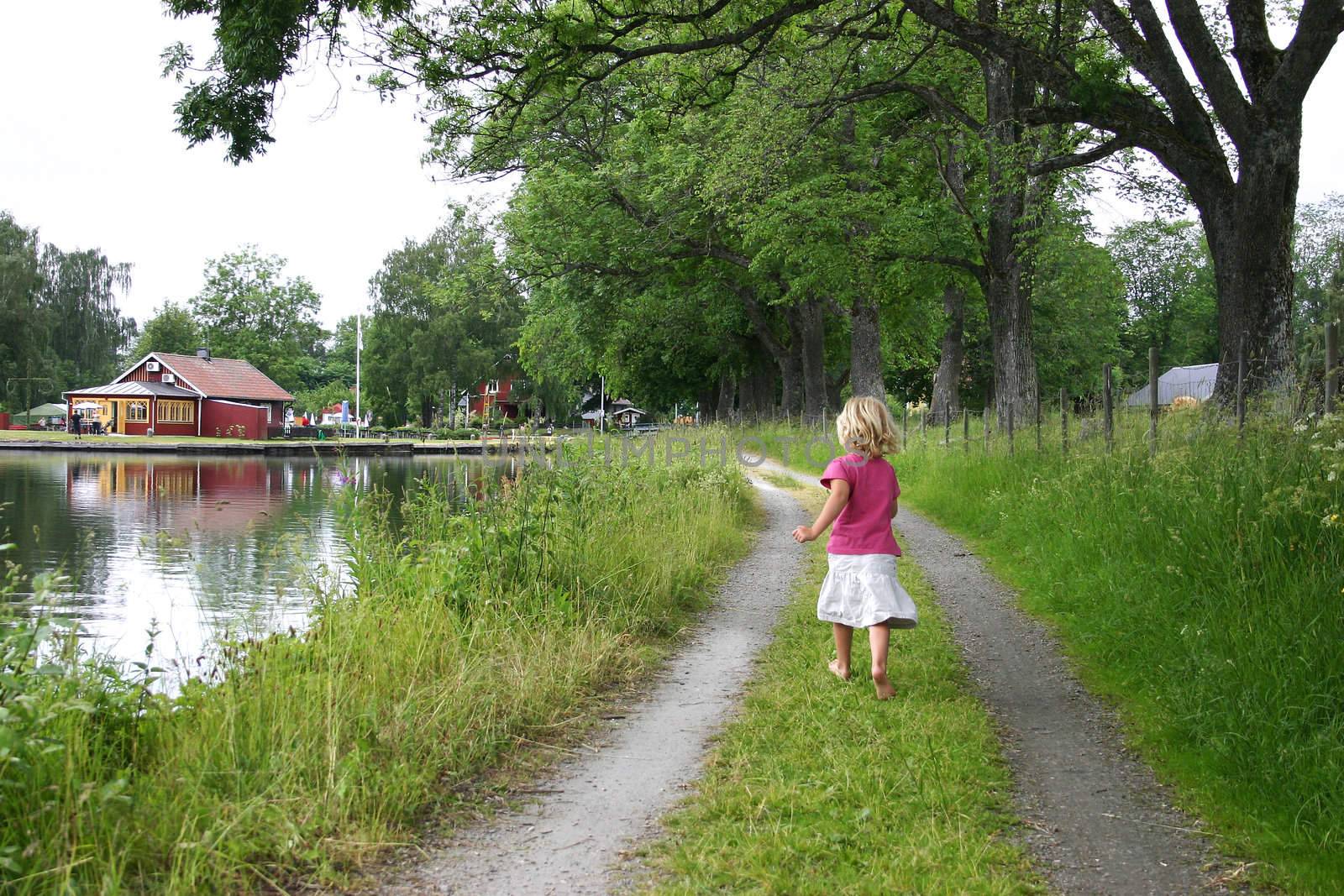 A little girl running along Gota kanal, Sweden