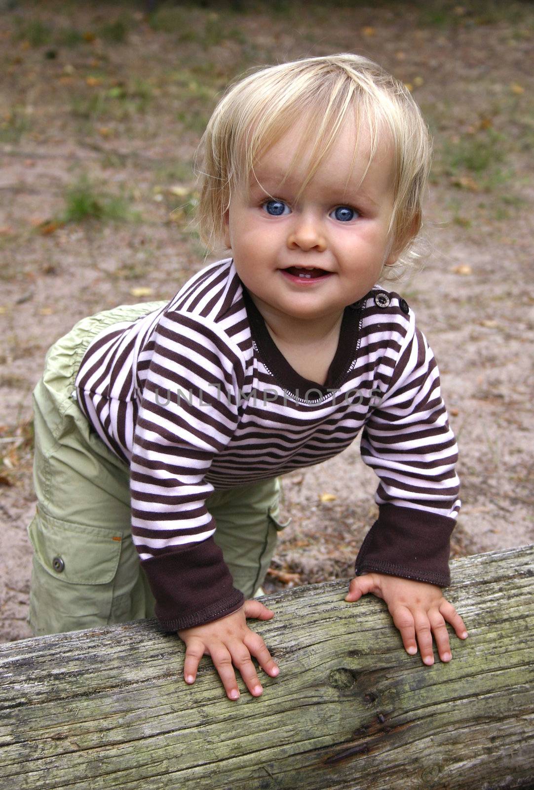 A happy toddlerwants to stand up and start to walk. Vertical. Happy feeling