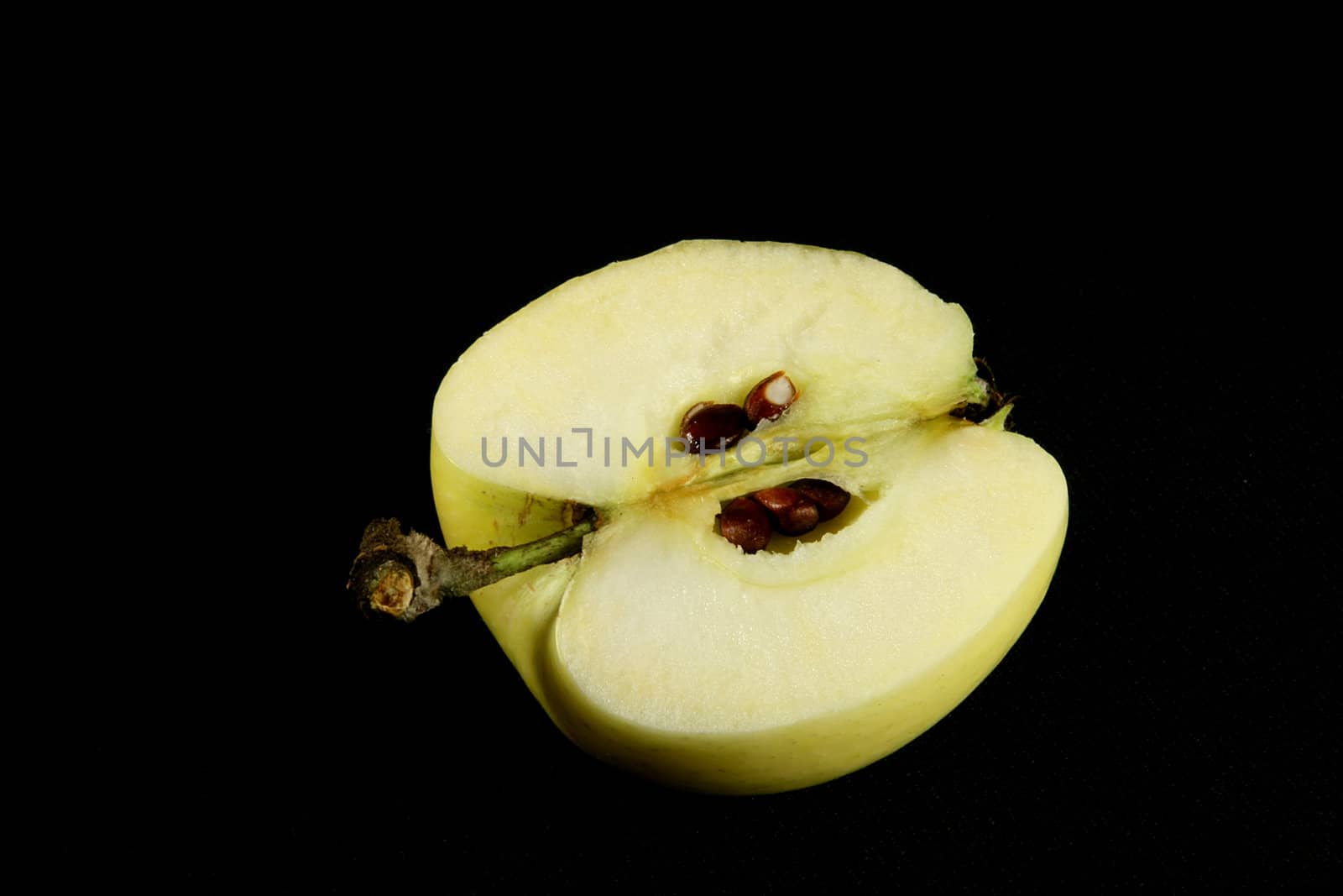 yellow apple on black background