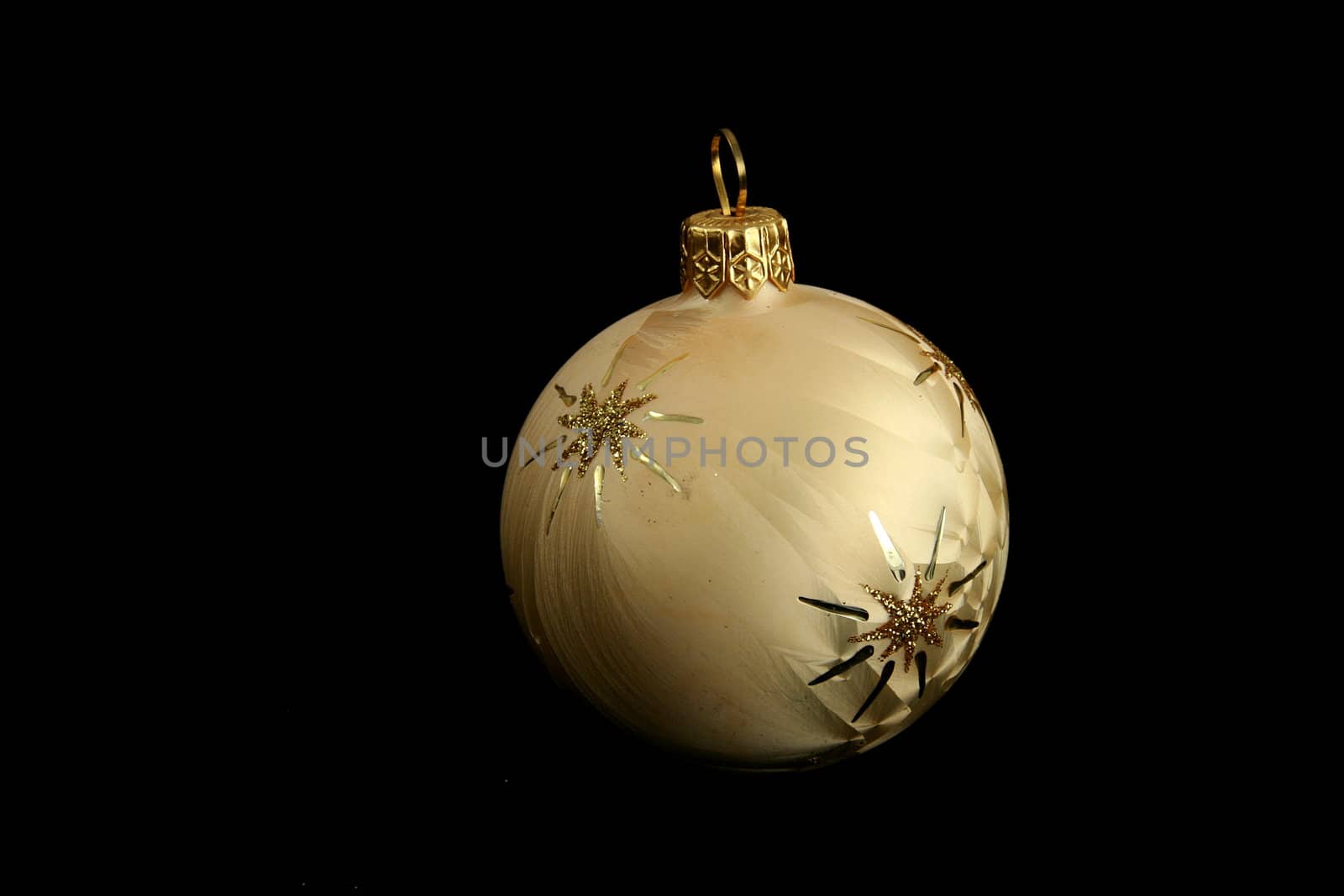 yellow decorative christmas ball isolated on black background