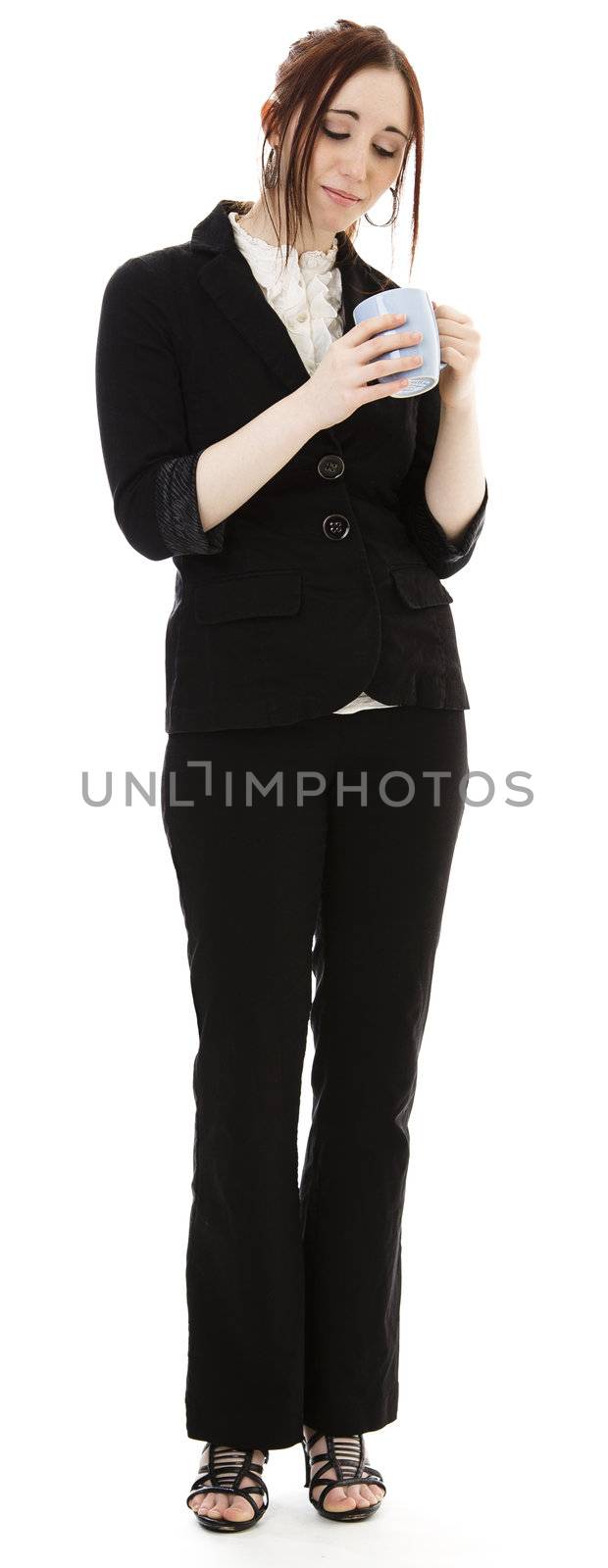 Young business woman looking into a coffee cup against white background
