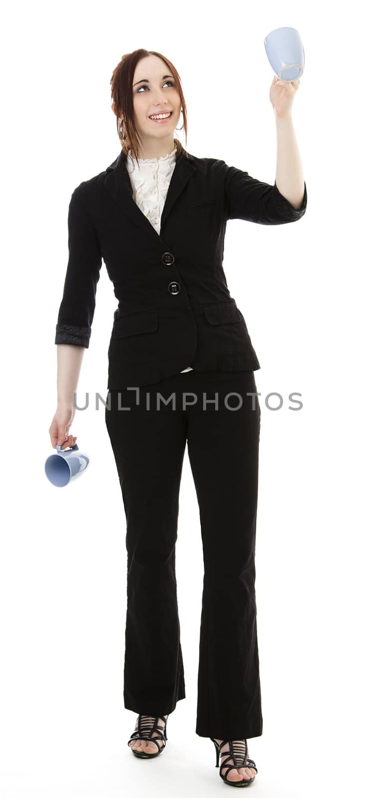 Young business woman juggling cup of coffee against white background