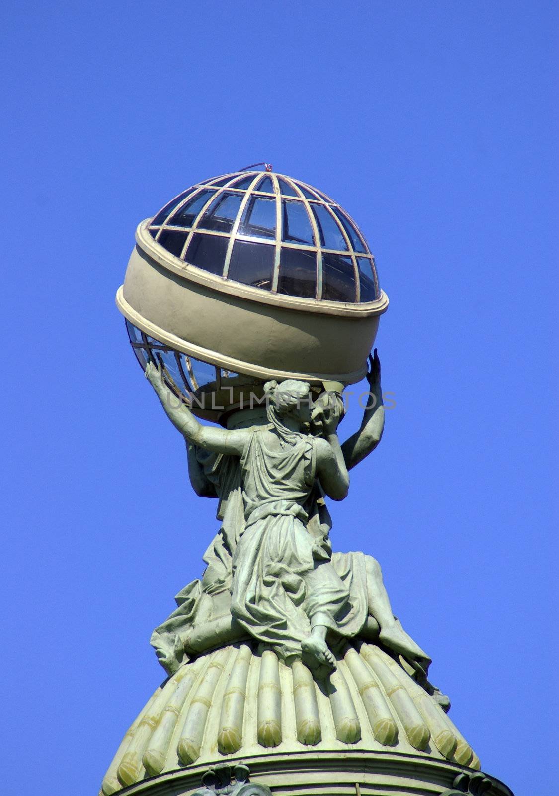 Fragment of a facade. Statue of a Greek holding a globe.