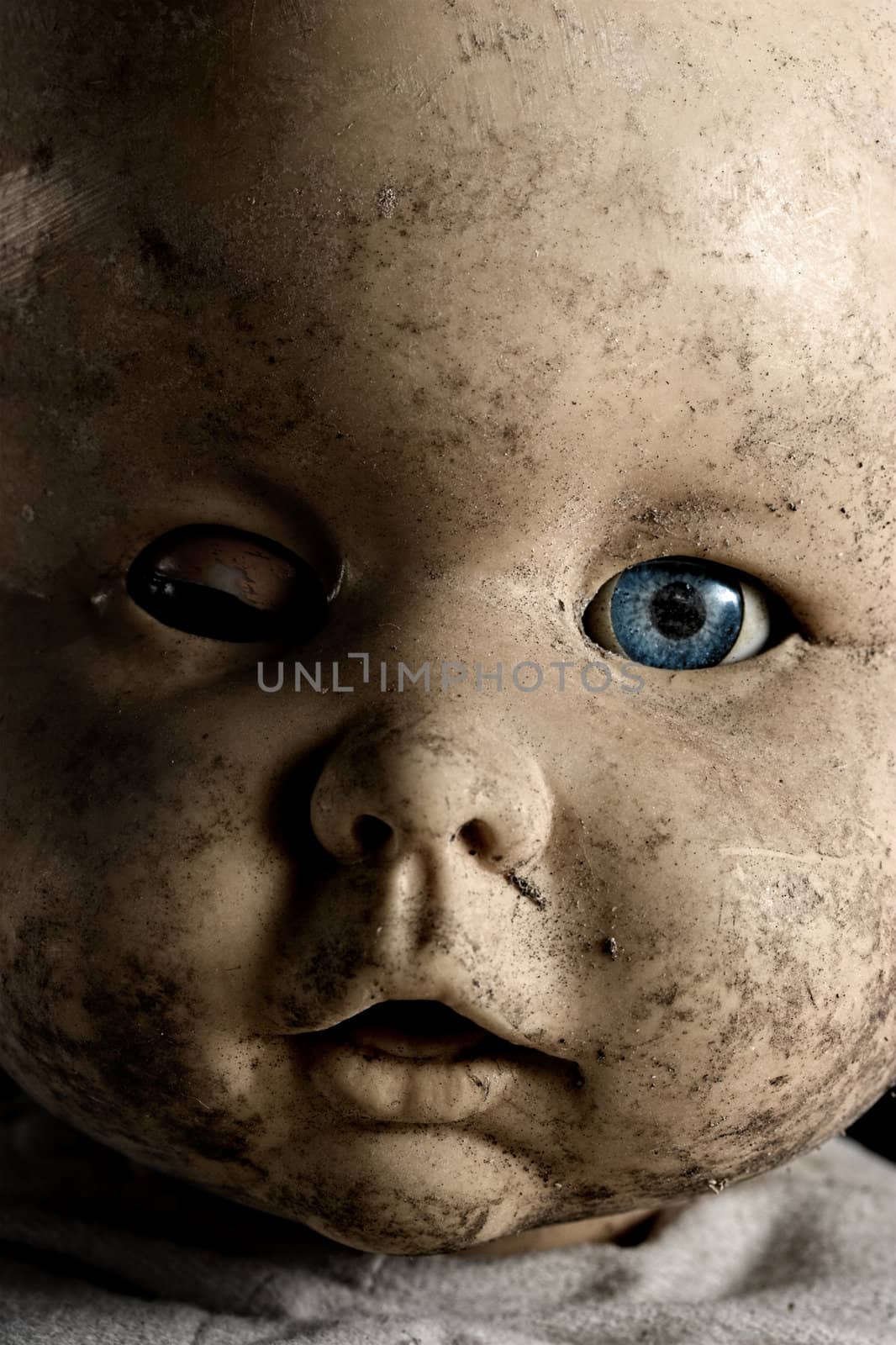 Close-up of baby doll with only on eye opened