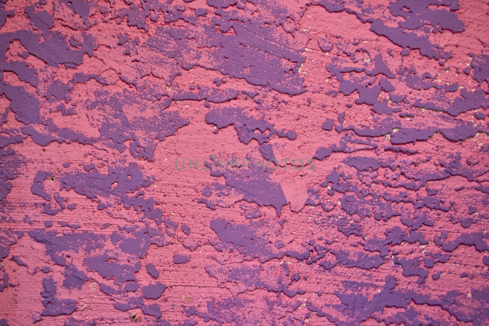 A textured background of pink and purple stucco.