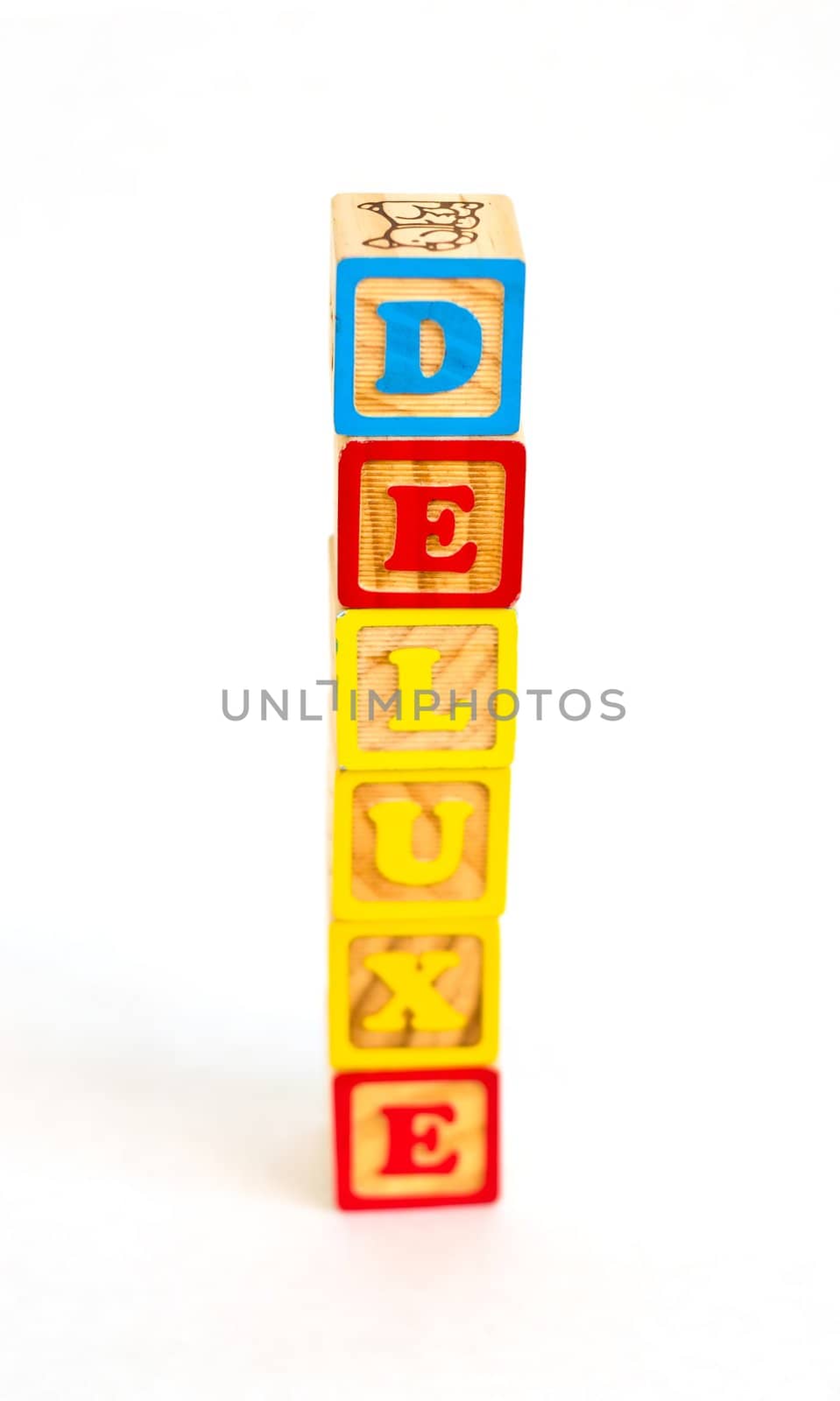 Vintage alphabet blocks spelling out DELUXE