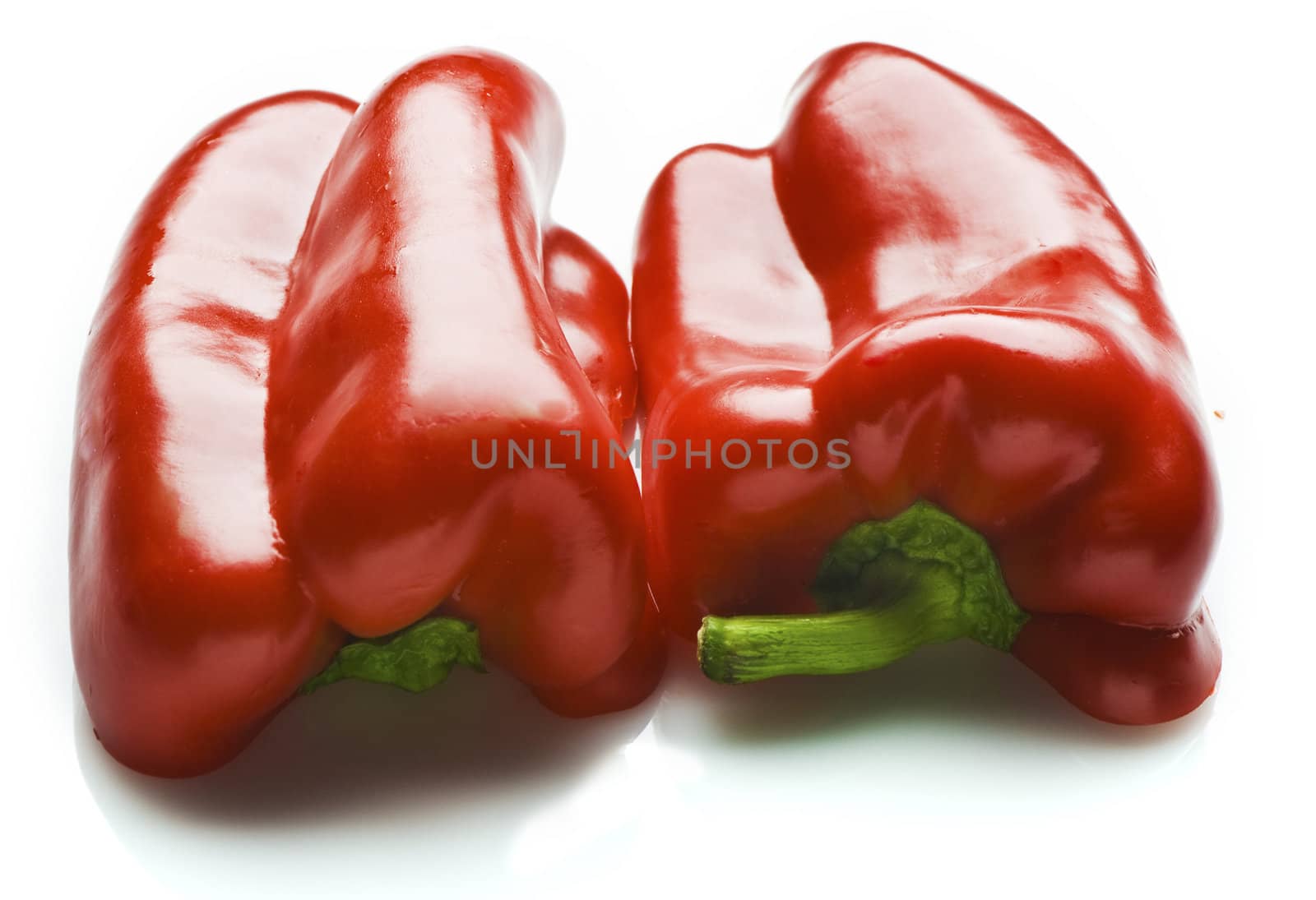 A red capsicum cut in half. Isolated on white.