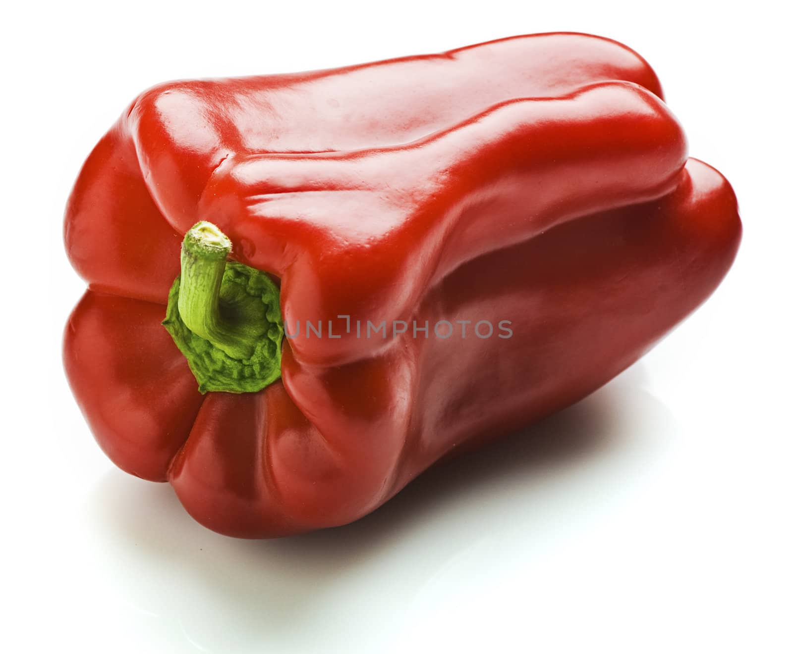 A whole red capsicum. Isolated on white.