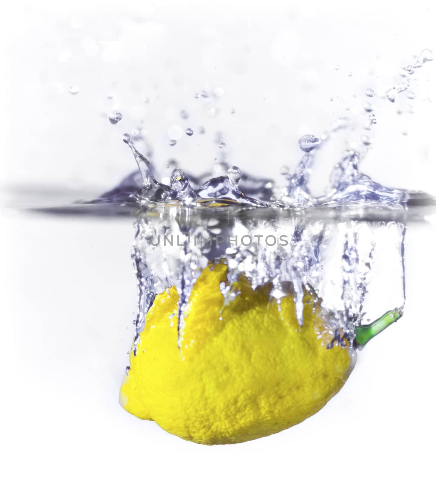 A lemon dropping into water creating a splash