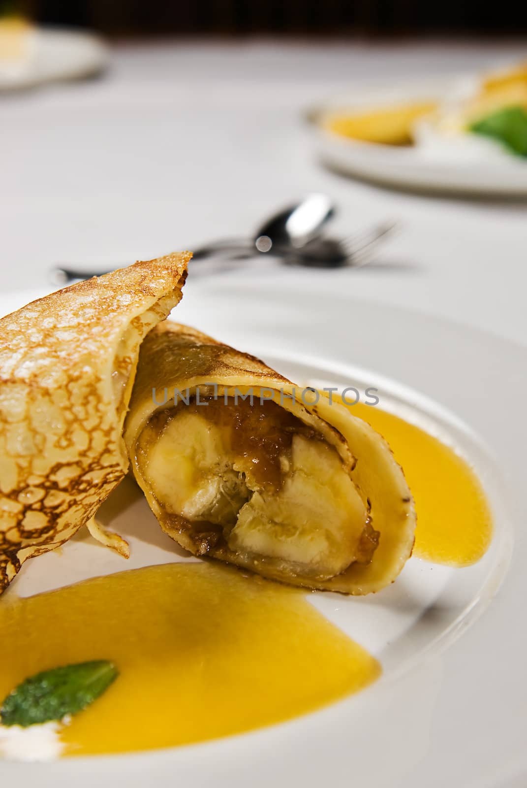 Caramel banana wrapped in a pancake with a sauce