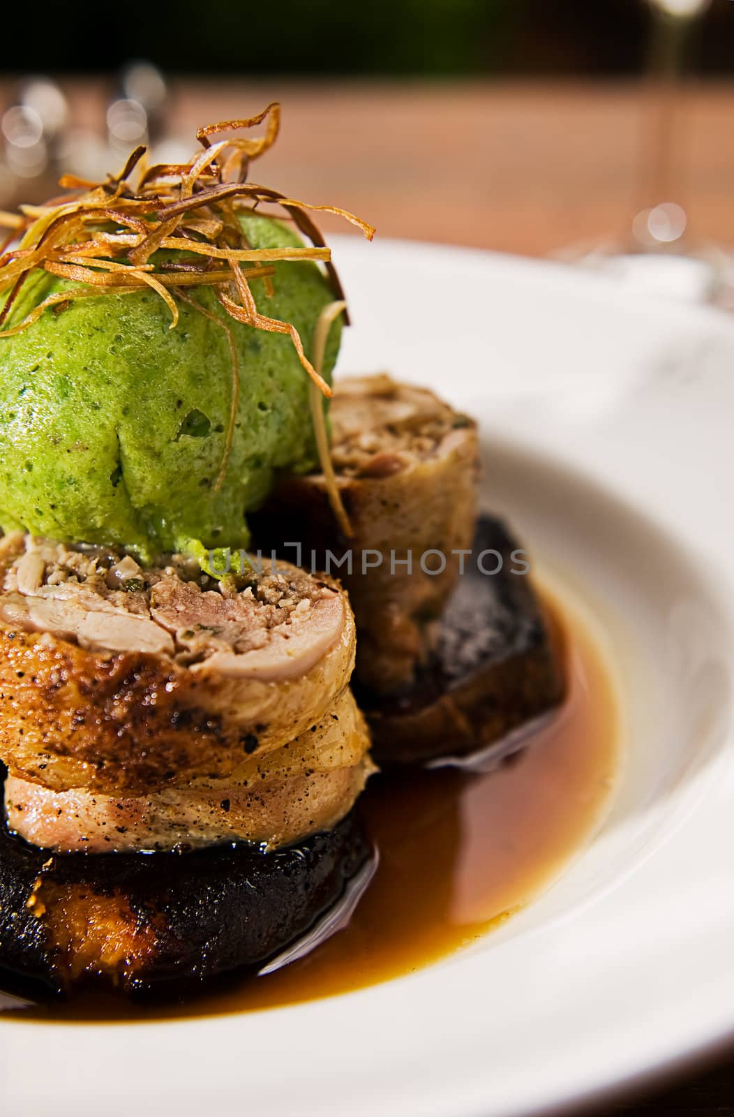 Chicken roulade with a Jerusalem artichoke & pork farce, sweet potato wedges, green pea 
dumpling & glaze