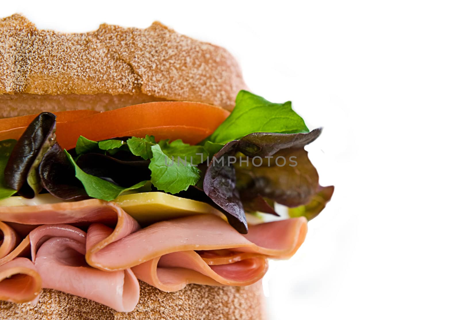 A gourmet sandwich of ham, cheese, lettuce, tomato and mayonaise isolated on white.