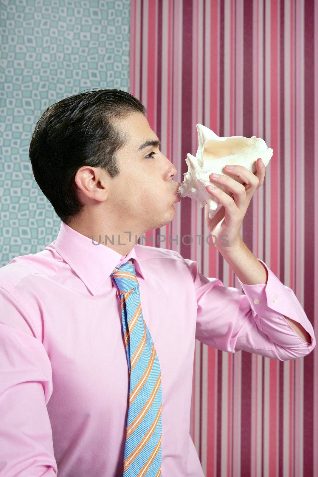 Businessman with sea shell, vacations metaphor in wallpaper office