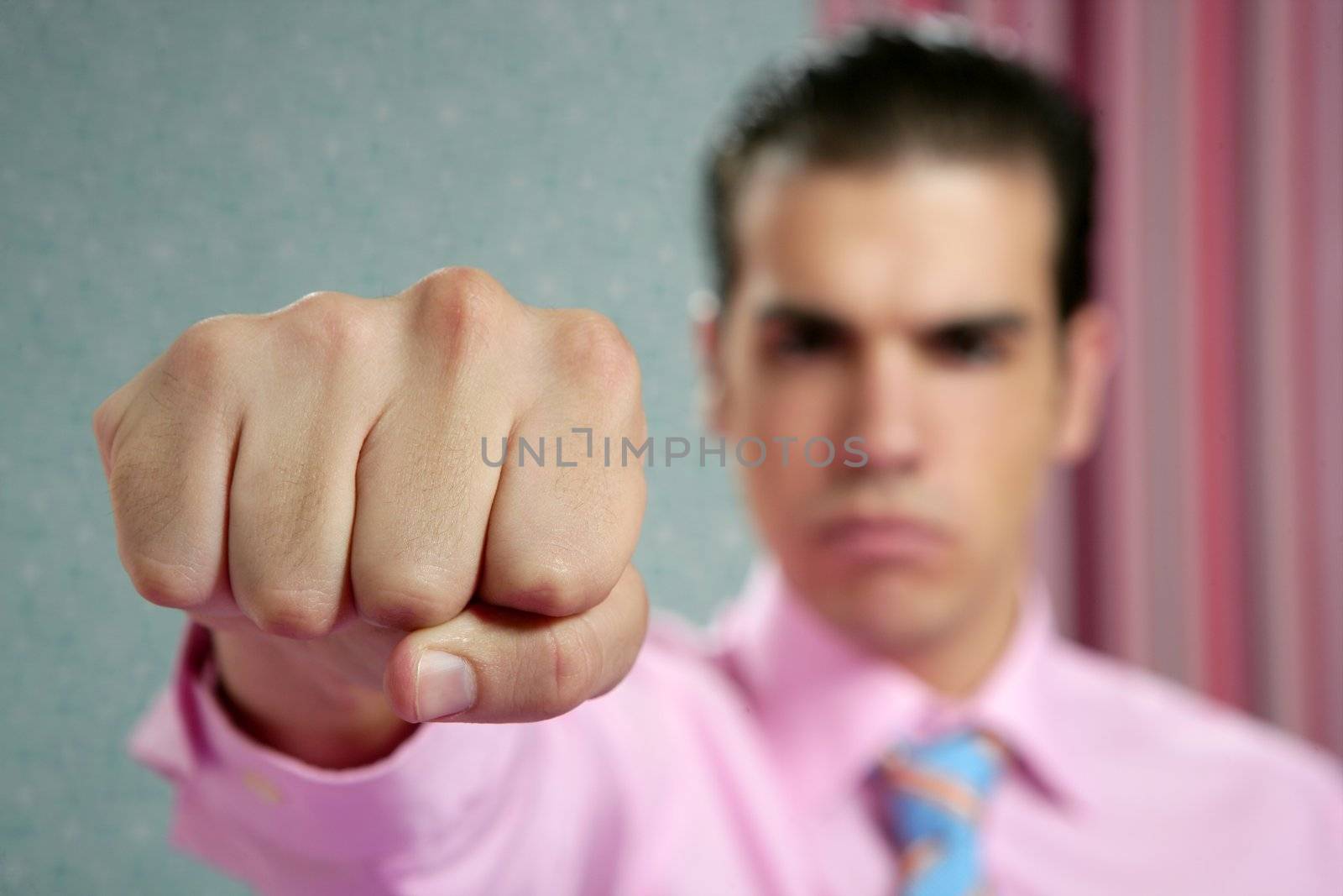 angry aggresive businessman with fist closeup to camera