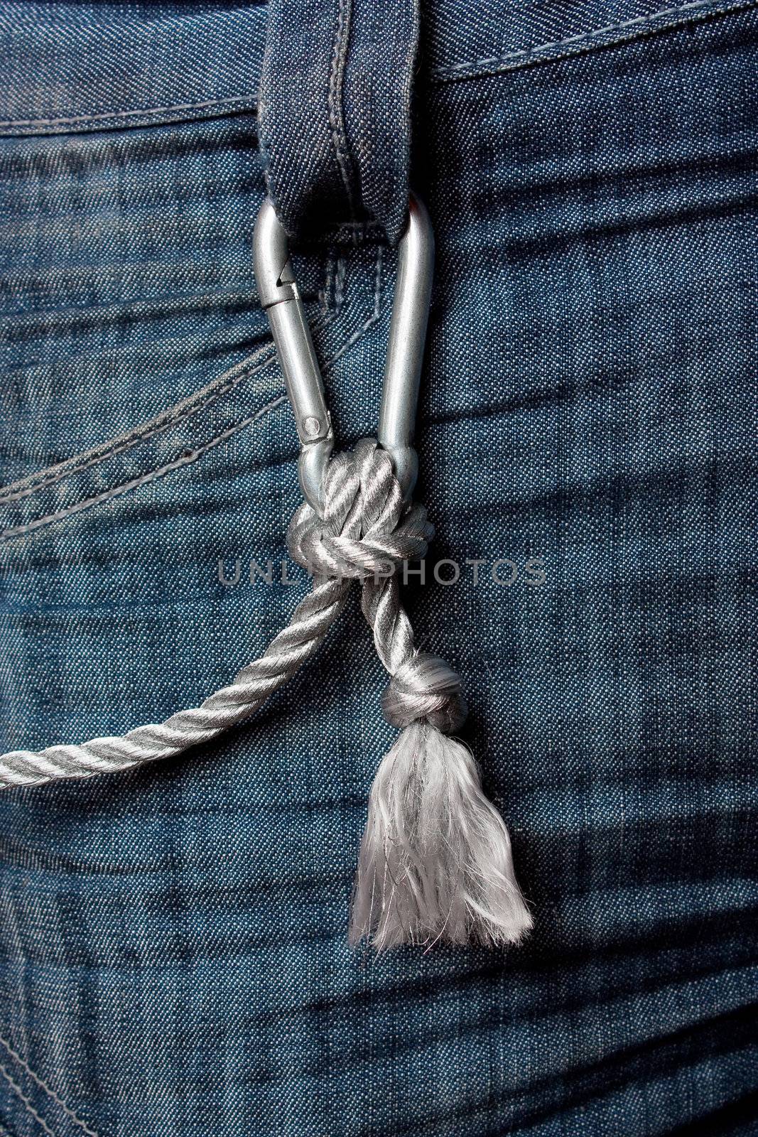 Carabiner climbing with a rope fastened to the jeans