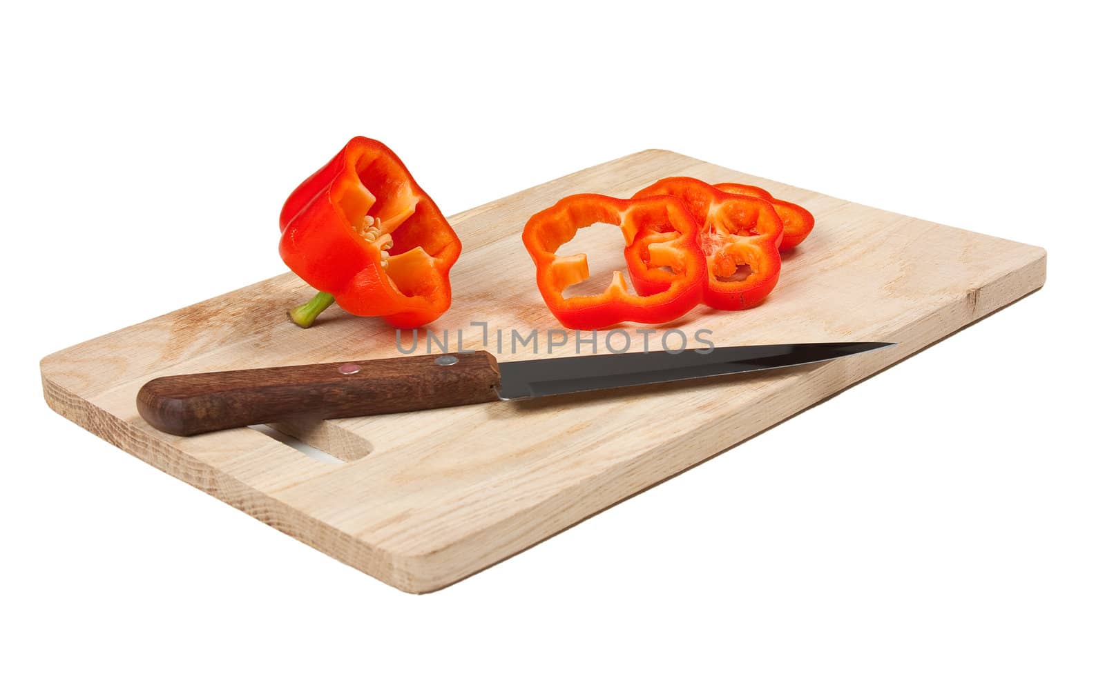 paprika with a knife on a cutting board isolated on a white background