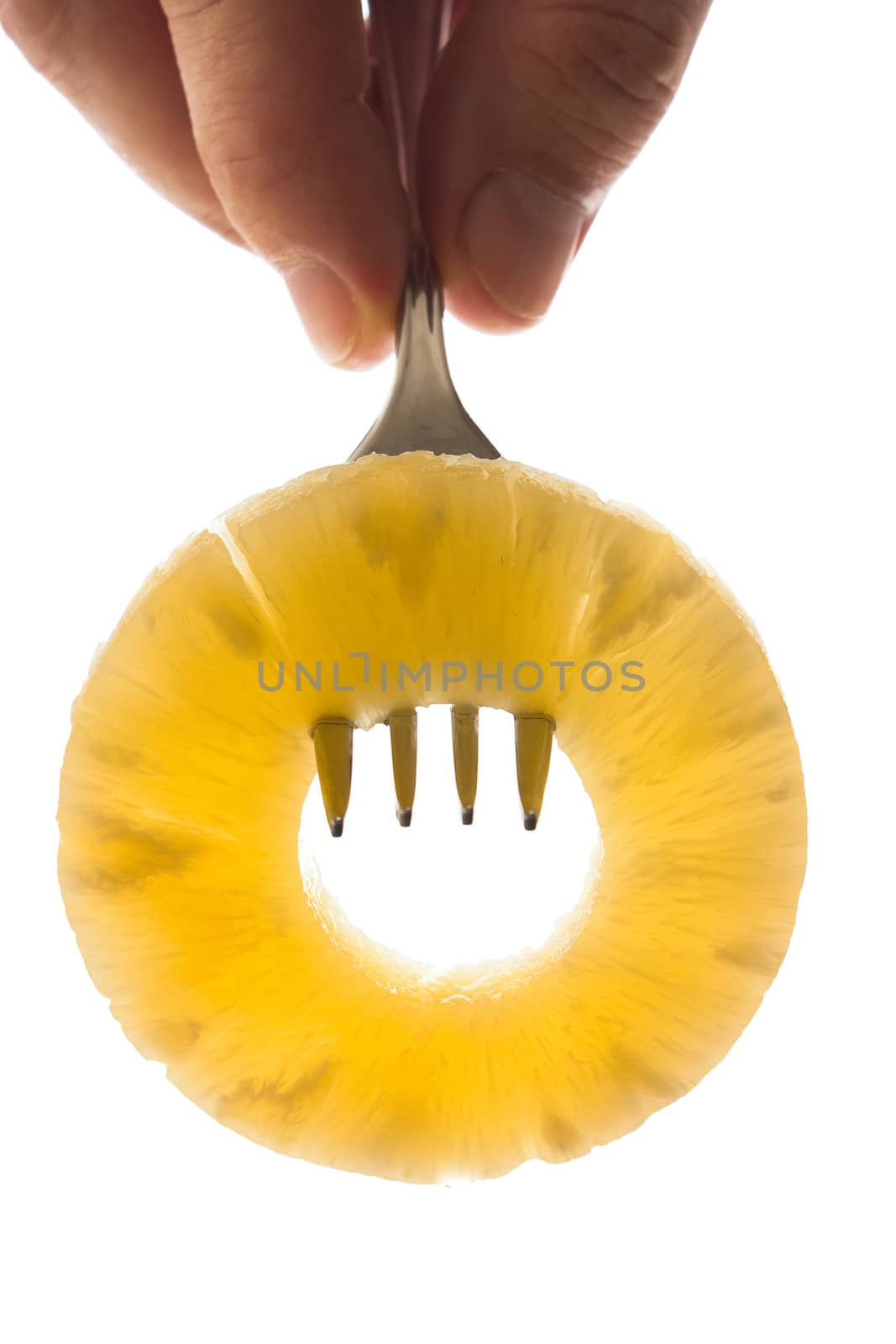 pineapple ring on a fork isolated on white background