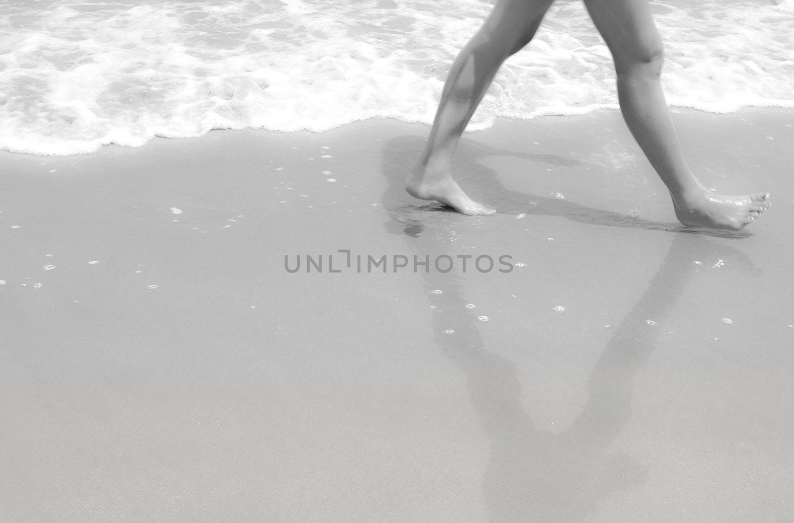 Legs walk on sand in black and white dreaming style