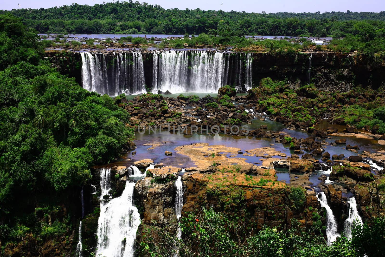 The Iguassu (or Iguazu) Falls is one of the largest masses of fresh water on the planet and divides, in South America, Brazil, Paraguay and Argentina. The waterfall system consists of 275 falls along 2.7 kilometres (1.67 miles) of the Iguazu River. Some of the individual falls are up to 82 metres (269 feet) in height, though the majority are about 64 metres (210 feet).