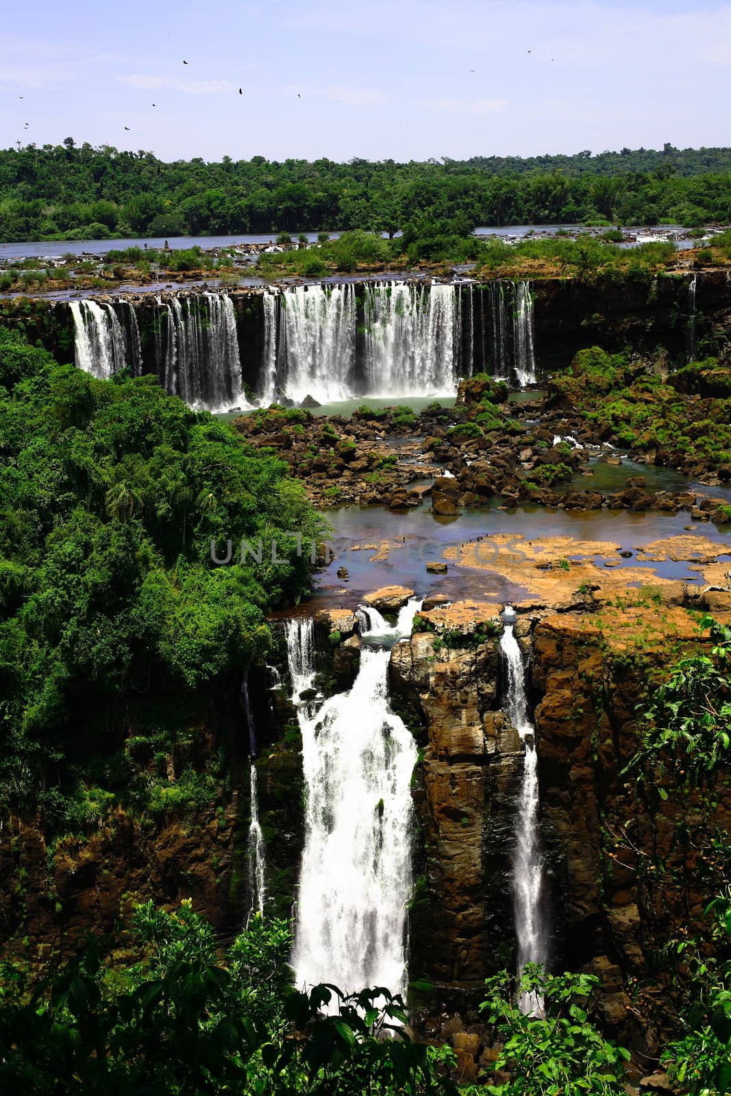 The Iguassu (or Iguazu) Falls is one of the largest masses of fresh water on the planet and divides, in South America, Brazil, Paraguay and Argentina. The waterfall system consists of 275 falls along 2.7 kilometres (1.67 miles) of the Iguazu River. Some of the individual falls are up to 82 metres (269 feet) in height, though the majority are about 64 metres (210 feet).