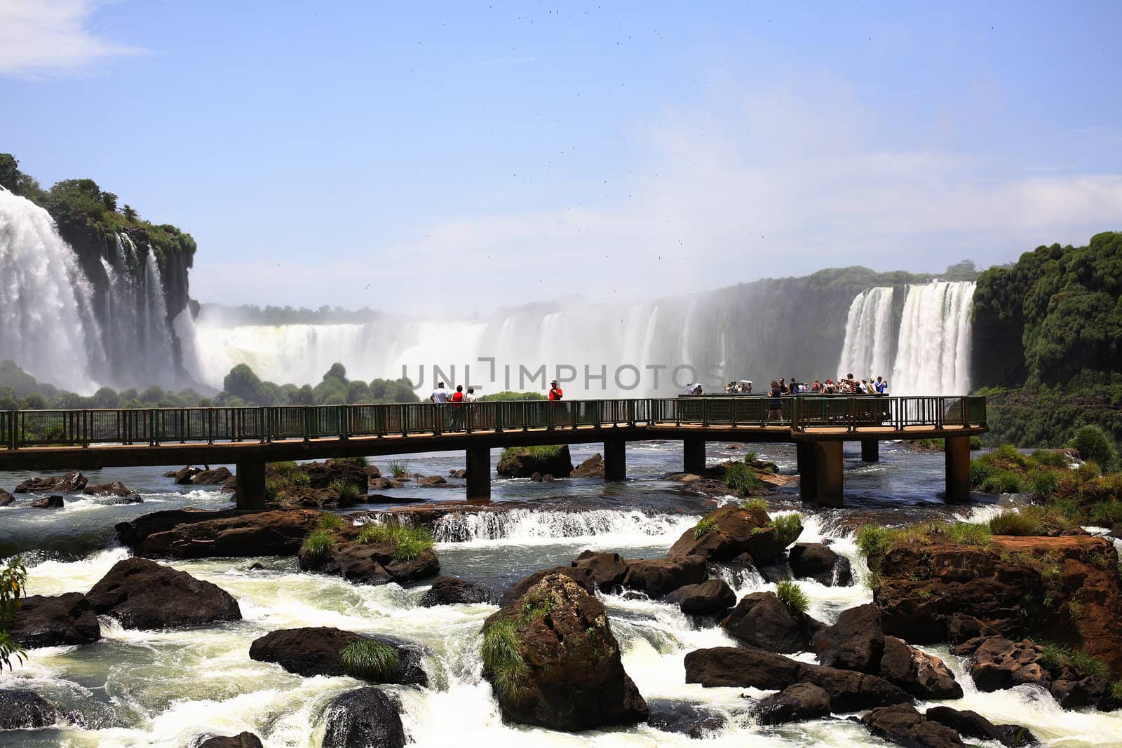 The Iguassu (or Iguazu) Falls is one of the largest masses of fresh water on the planet and divides, in South America, Brazil, Paraguay and Argentina. The waterfall system consists of 275 falls along 2.7 kilometres (1.67 miles) of the Iguazu River. Some of the individual falls are up to 82 metres (269 feet) in height, though the majority are about 64 metres (210 feet).