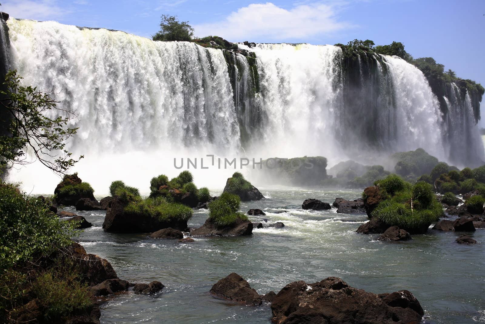 The Iguassu (or Iguazu) Falls is one of the largest masses of fresh water on the planet and divides, in South America, Brazil, Paraguay and Argentina. The waterfall system consists of 275 falls along 2.7 kilometres (1.67 miles) of the Iguazu River. Some of the individual falls are up to 82 metres (269 feet) in height, though the majority are about 64 metres (210 feet).